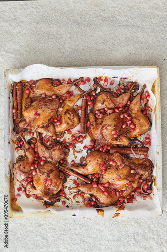 Roasted poussin with pomegranate seeds and cinnamon photo