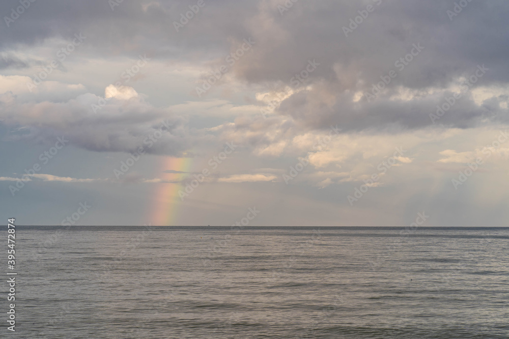 sea scape against rainbow background.
