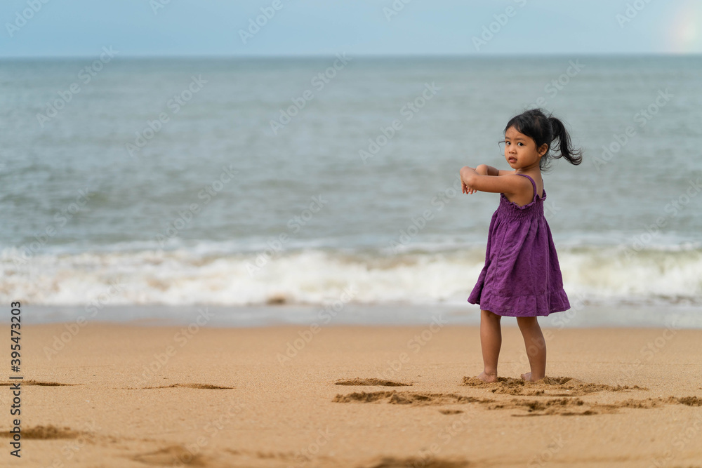 Cute little girl playing on the beach in morning. Cute little girl playing on the beach in morning.