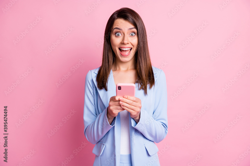 Photo of young happy smile blogger girl use cellphone excited surprised news like wear jacket isolated over pastel color background Photo of young happy smile blogger girl use cellphone excited surprised news like wear jacket isolated over pastel color background