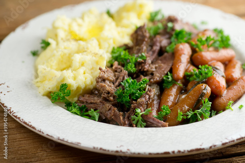 Pot roast with baby carrots and mashed potatoes photo