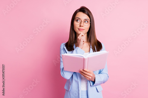 Photo of young girl hold notebook book dreamy think thoughtful look empty space isolated over pastel color background