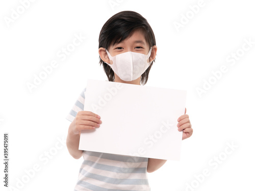 Cute Asian child with protection mask holding white paper on white background isolated
