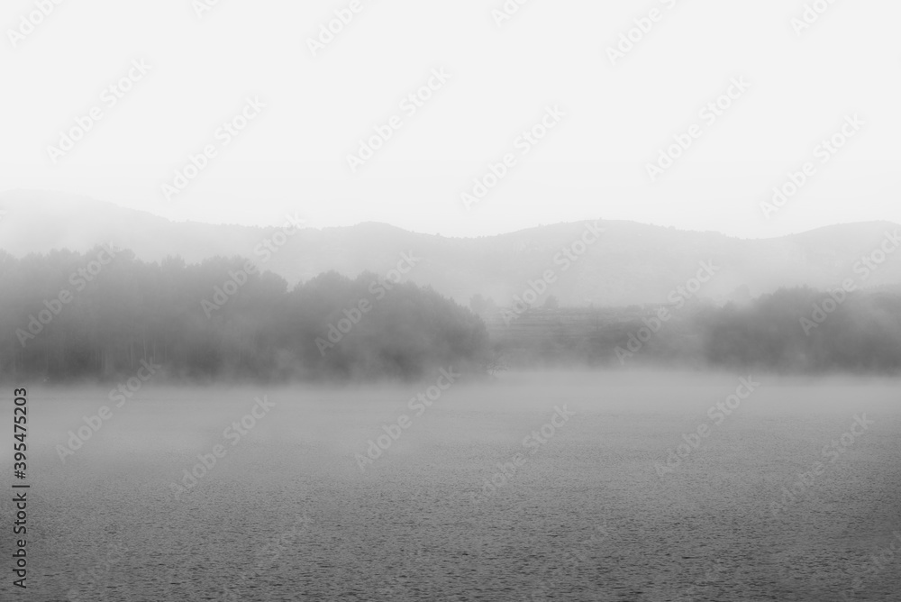 Fototapeta premium Fog in the dam reservoir in black and white