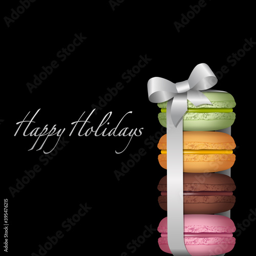 Carte d’invitation à la gourmandise avec une série de macarons au parfum différents de fraise, chocolat, pistache, orange, empilés les uns sur les autres et réunis par un ruban argent.