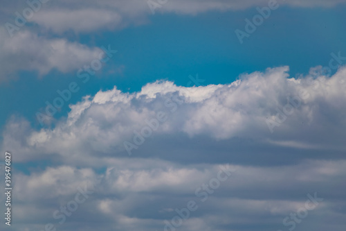 Fototapeta Naklejka Na Ścianę i Meble -  The blue sky is rich in color in clear weather with beautiful lush clouds. The beauty of nature in the fresh air, the layer of atmosphere visible to the eye from bottom to top