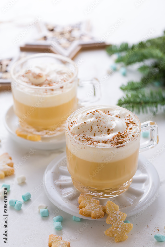 Eggnog with cinnamon and nutmeg with small tree cookies for Christmas and winter holidays Eggnog with cinnamon and nutmeg with small tree cookies for Christmas and winter holidays