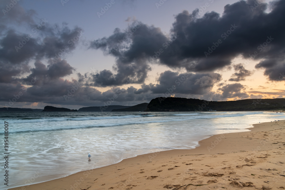 Fototapeta premium Cloudy sunset seascape with waves