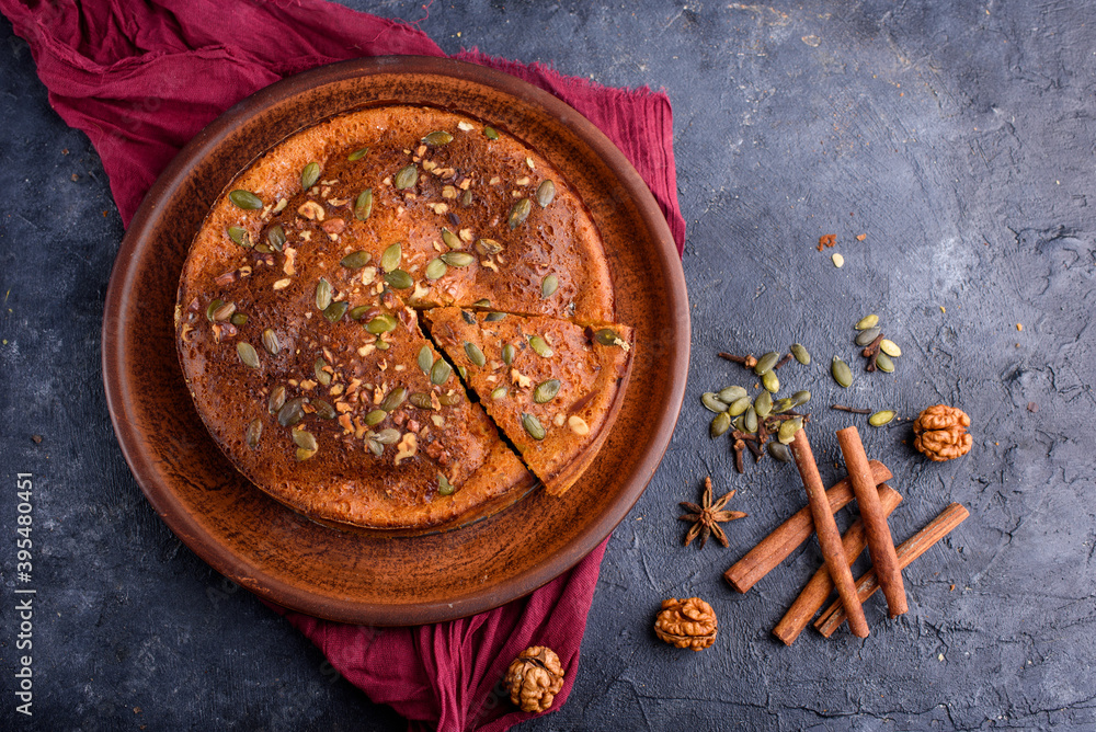 Pumpkin pie with lemon zest, pumpkin seeds, cinnamon, fragrant spices and spices on a dark background. Healthy food Pumpkin pie with lemon zest, pumpkin seeds, cinnamon, fragrant spices and spices on a dark background. Healthy food