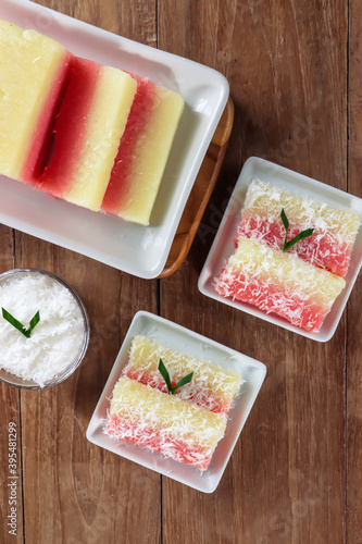 Sentiling is Indonesian traditional snack made from steamed grated cassava with food grade colorants and served with steamed fresh grated coconut. photo