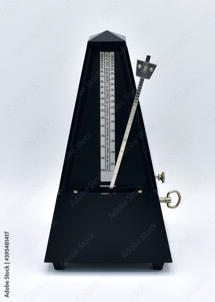Black metronome isolated on a white background.