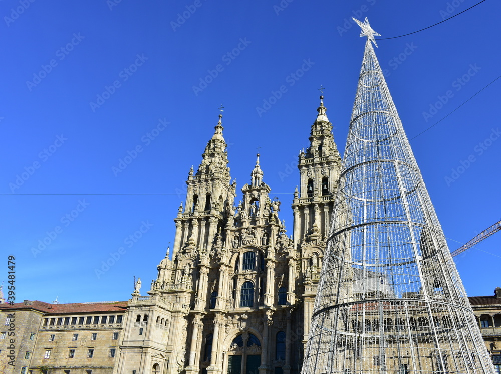 Cathedral, facade view from Praza do Obradoiro with blue sky and Christmas tree. Santiago de Compostela, Galicia, Spain, Europe.
