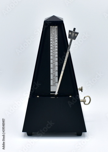Obraz na płótnie Black metronome isolated on a white background. w salonie