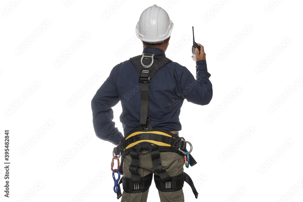Obraz premium Workers standing with hand holding walkie-talkie wearing safety helmet and equipment safety harness on white background with clipping paths