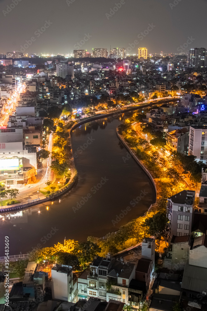 Aerial sunset view of Cau Kieu bridge and houses in Saigon, Vietnam. Business and Administrative Center of Ho Chi Minh city on NHIEU LOC canal.