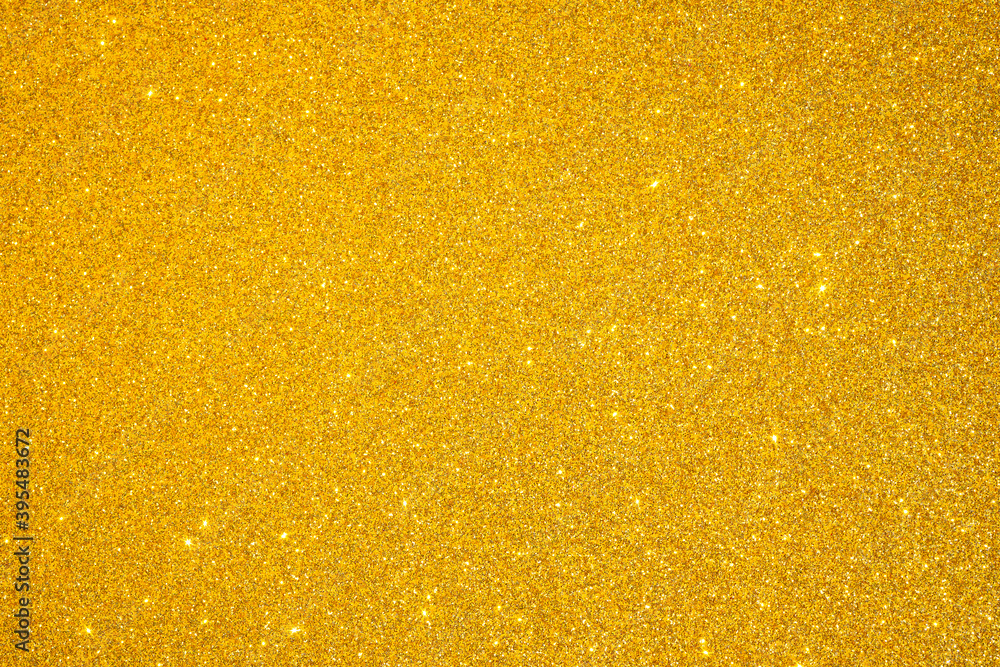 Trendy color Fortuna gold background with glitter and feather. Christmas background.