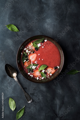 Strawberry and rhubarb cream soup, spiced with ginger and cardamon, topped with frrsh mint leaves, strawberries, feta cheese, pumpkin seeds, chia seeds and sunflower seeds photo