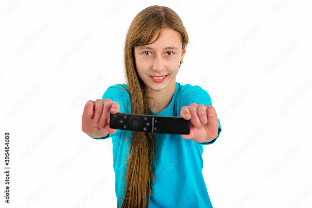 Girl kid child holds tv remote control.White studio wall.Close up. Girl kid child holds tv remote control.White studio wall.Close up.