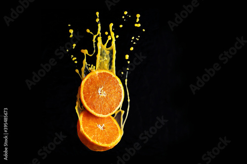 Orange flying in the juice splashes photo