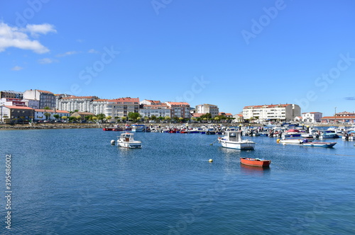 Harbour and coastal village with galician fishing vessels, rowboats and sailing boats at famous Rias Baixas in Galicia Region. Portosin, Coruña, Spain. 