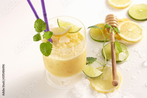 Mango rice shake with lime and honey in a glass with a drinking straw photo