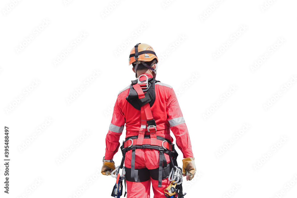 Male rope access worker wearing full safety harness clipping Karabiner into harness loop prior to abseiling working at height construction site isolated on white background clipping paths. Male rope access worker wearing full safety harness clipping Karabiner into harness loop prior to abseiling working at height construction site isolated on white background clipping paths.