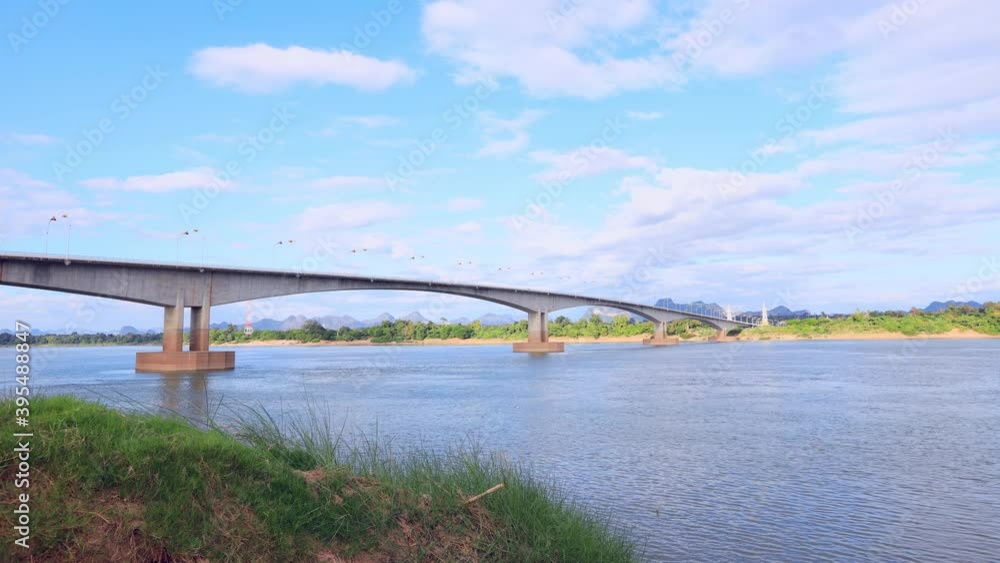 Time lapse of Third Thai-Lao Friendship Bridge with clear blue sky and white cloud, Bridge over the Mekong River Nakhon Phanom province to border shore, Khammouane of Leo Time lapse of Third Thai-Lao Friendship Bridge with clear blue sky and white cloud, Bridge over the Mekong River Nakhon Phanom province to border shore, Khammouane of Leo