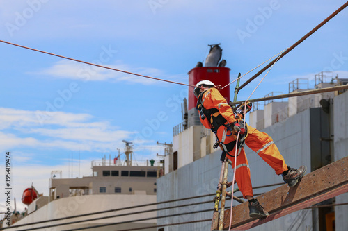 Safety concept in shipyard The man wearing epuipment for abseiling rope access on scaffolding photo