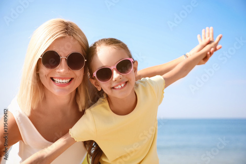 Mother and daughter at beach. Family vacation © New Africa