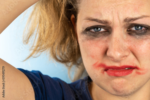The woman with smeared makeup winced in pain.
