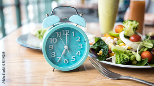 Time to lose weight and selective focus of blue clock and eating control or time to diet concept-Intermittent fasting