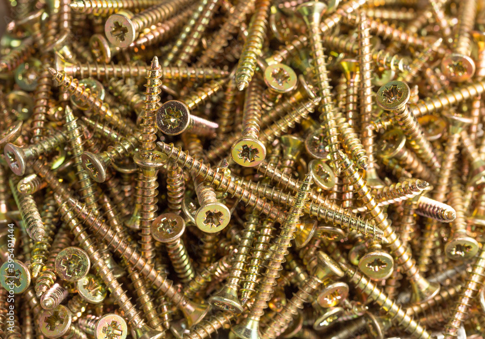 Golden Screws background, top view closeup macro Golden Screws background, top view closeup macro