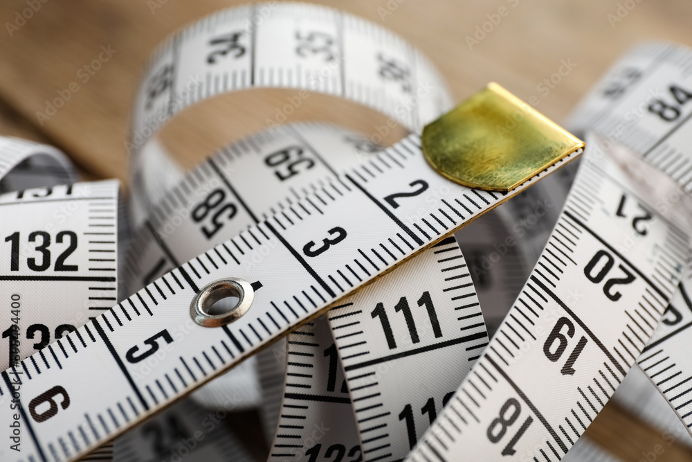 New white measuring tape on table, closeup New white measuring tape on table, closeup