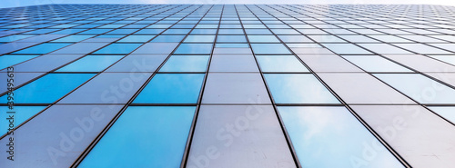 glass facades of modern office buildings and reflection of blue sky