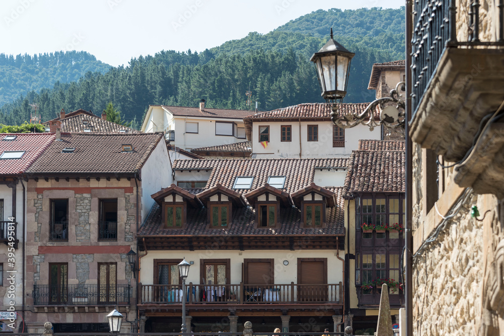 Ancient stone-made buildings with tiled roofs and small balconies in Potes, Cantabria, Spain