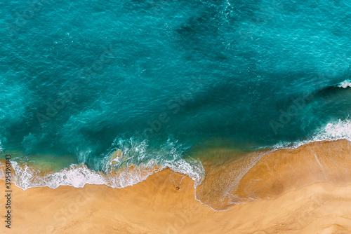 Beautiful sandy beach with turquoise water. Wild beach with beautiful clear sea. Yellow sand with turquoise sea. Clean beach with clean sea. Ocean from a bird's eye view. Copy space