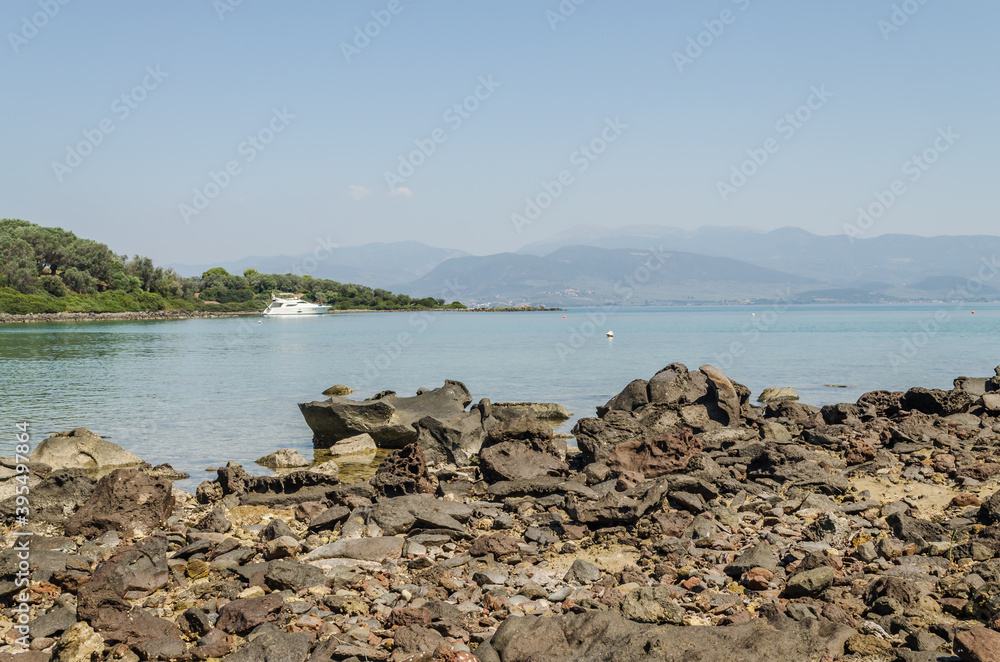 Evia island, Greece - July 01. 2020: Anchored yacht at the beach shore