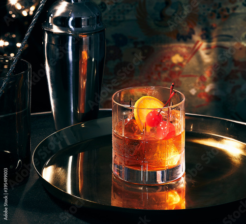An Old Fashioned cocktail on a tray