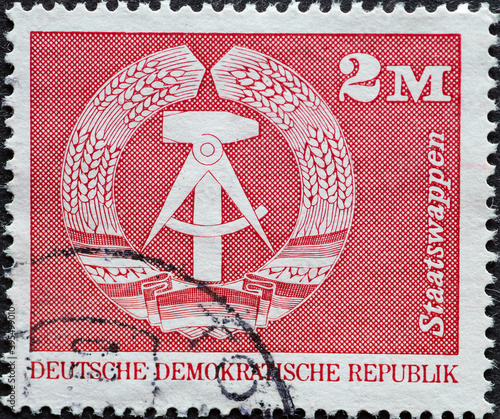 GERMANY, DDR - CIRCA 1974 : a postage stamp from Germany, GDR showing the national coat of arms of the German Democratic Republic