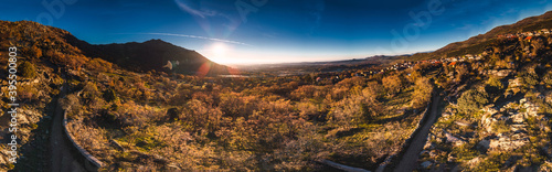 Panoramic View of the sunrise in the mountains hdr with trees and roads with blue sky