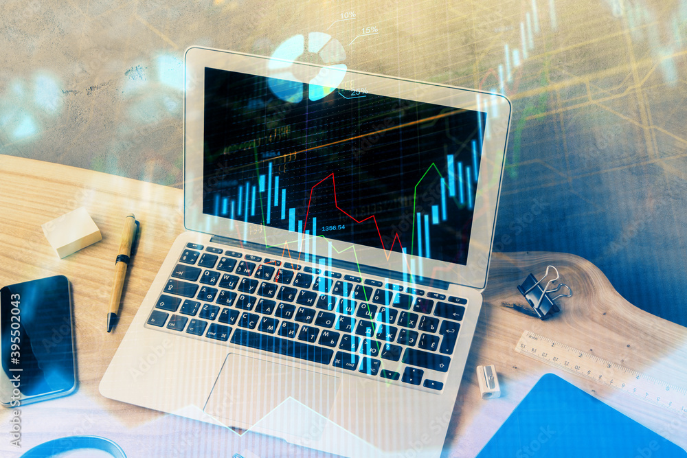 Multi exposure of graph and financial info and work space with computer background. Concept of international online trading. Multi exposure of graph and financial info and work space with computer background. Concept of international online trading.