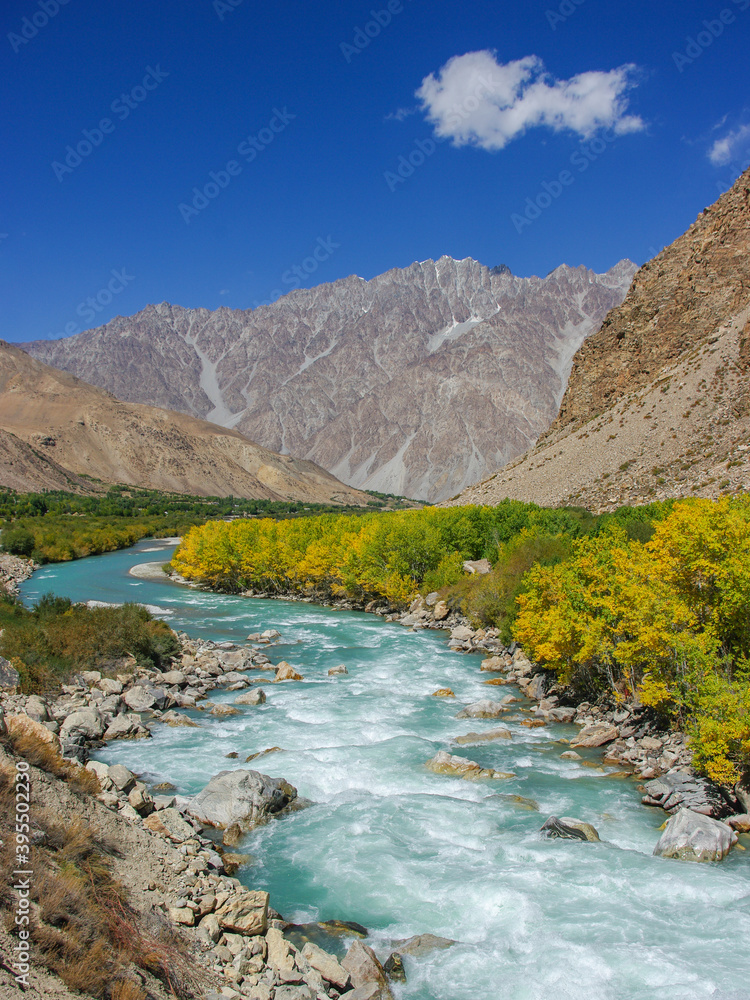 Colorful scenic landscape view of the Gunt river valley with turquoise blue water and golden foliage, Gorno-Badakshan, Tajikistan Pamir