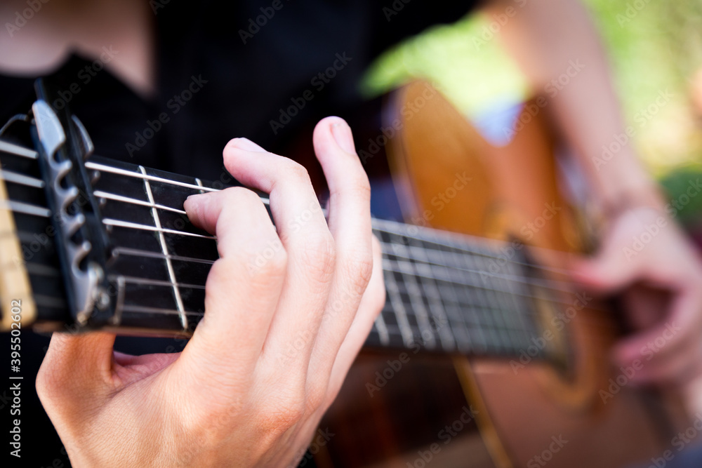 Spanish guitar. Man playing Spanish guitar with detail on his hands Spanish guitar. Man playing Spanish guitar with detail on his hands
