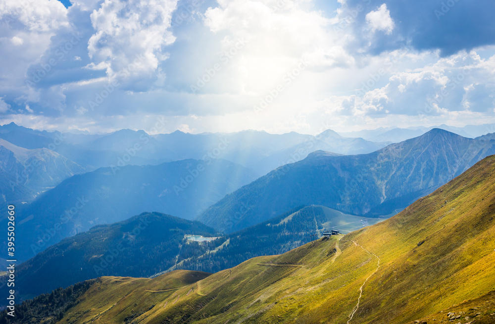 A great view over the Austrian Alps with sun rays through the clouds.