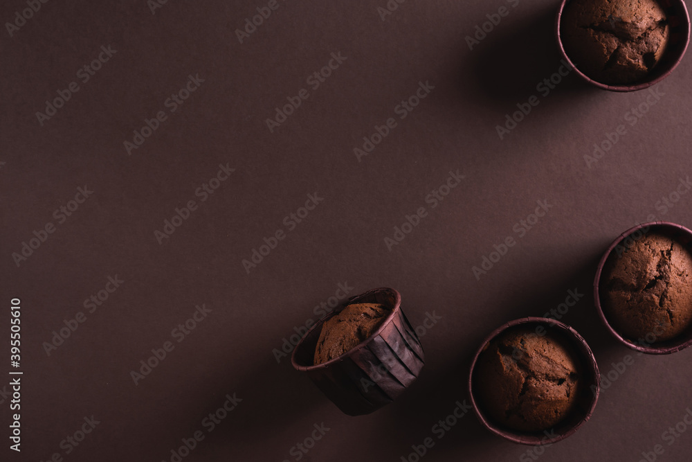 Chocolate cupcakes on a brown background
