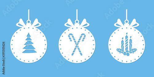 Christmas balls with a silhouette for cutting. Christmas ornament stencil. Xmas tree drawing, candy cane, candles and holly. Ball with a bow. Window decoration, craft, laser carving from wood. Vector