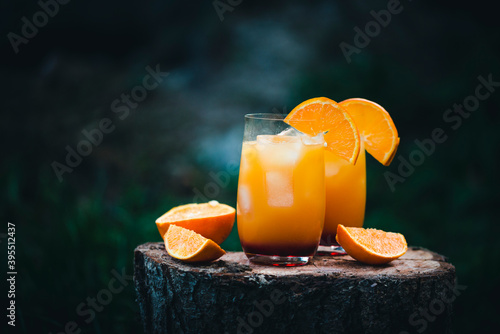 Two glasses of Vodka Sunrise made with orange juice and grenadine photo