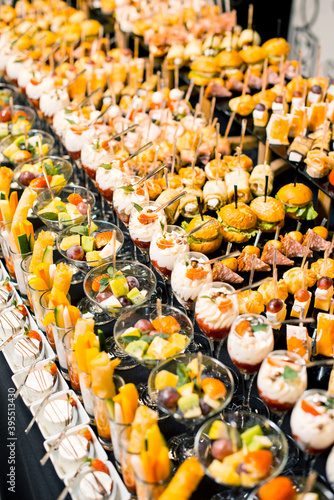 Konstfotografi Vertical photo of a lot of delicious desserts and aperitives on a party table