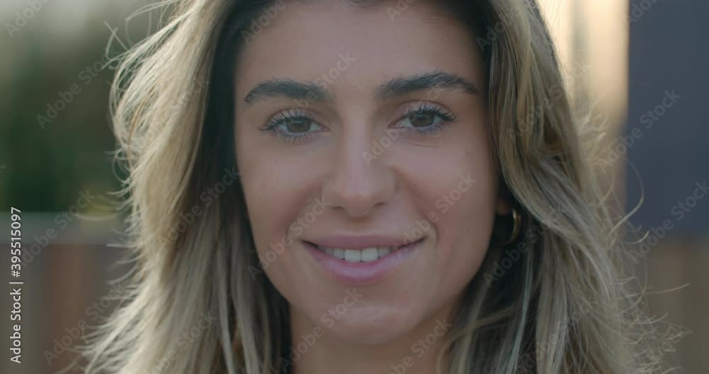 Close up view of happy young woman with blond hair looking to camera. Headshot of pretty female person smiling and posing. Outdoors. Close up view of happy young woman with blond hair looking to camera. Headshot of pretty female person smiling and posing. Outdoors.
