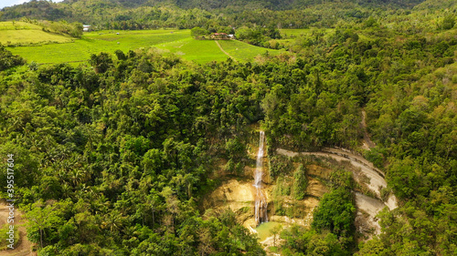 Tropical landscape: Beautiful waterfall and rice terraces. Aerial view of Can-umantad Falls. photo